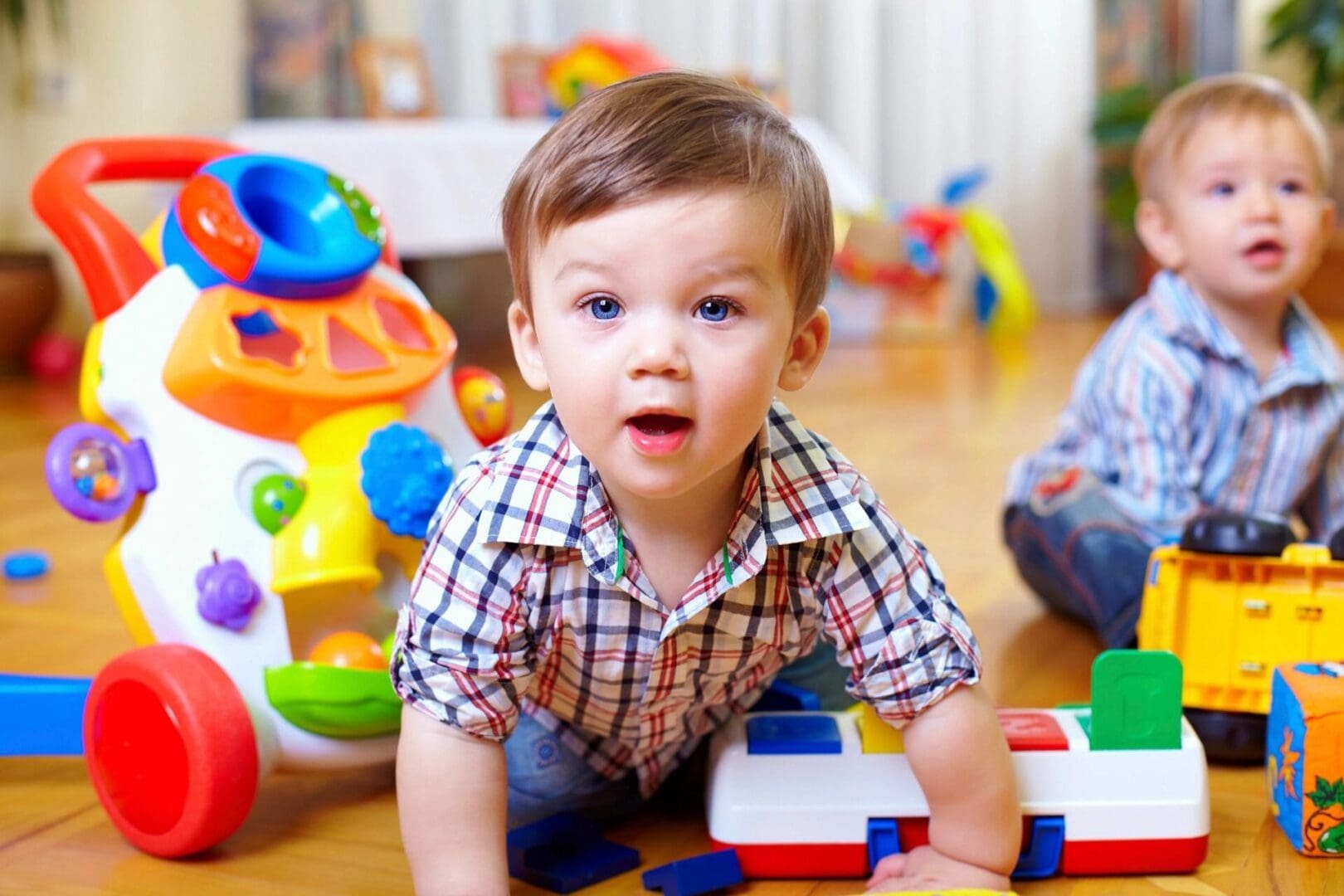 A baby is playing with toys on the floor.