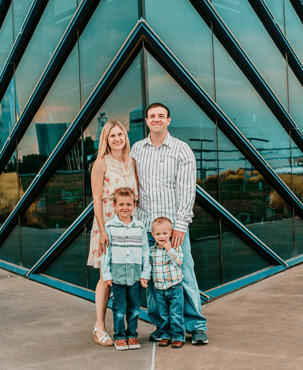 A family posing for a picture in front of a building.